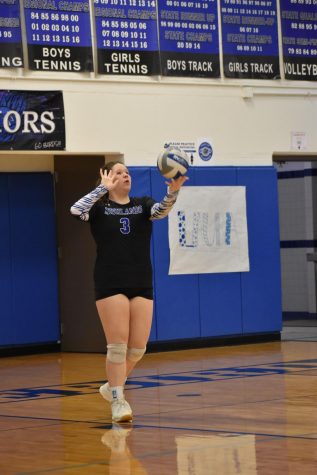 Senior Maria Little prepares to serve the ball.