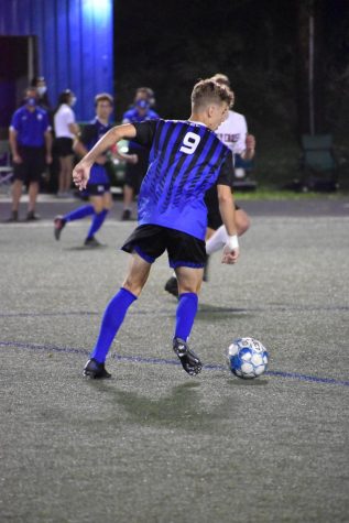 Senior Austin Frazier dribbles the ball down the field.