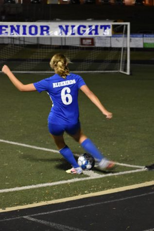 Junior Jade Rehberger signals to her teammates for a corner kick.