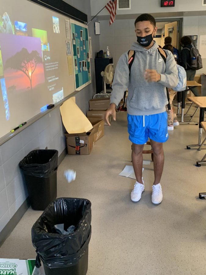 Freshman Ty Boler shoots his paper towel into the trashcan as class ends. 