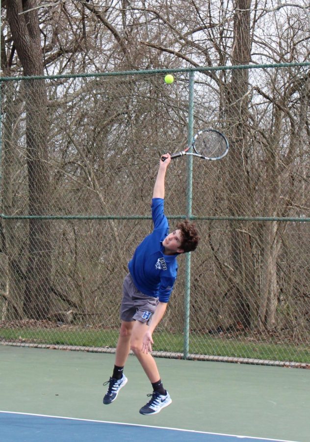 Freshman Eli Hornsby serves to his Cooper HS opponent.
