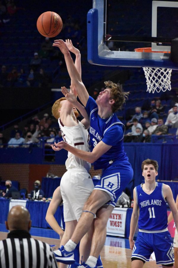Senior Sam Vinson meets his competitor at the rim, blocking his attempted dunk. 