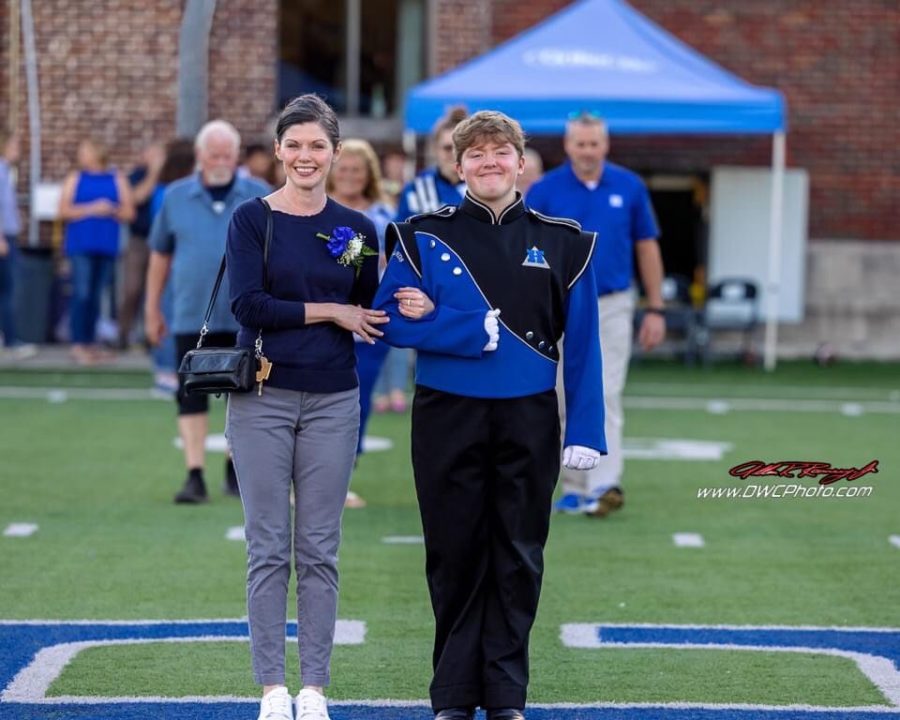 Senior Brandon Anderson and his mother Maria Anderson walk out together during the Senior Night football game. 