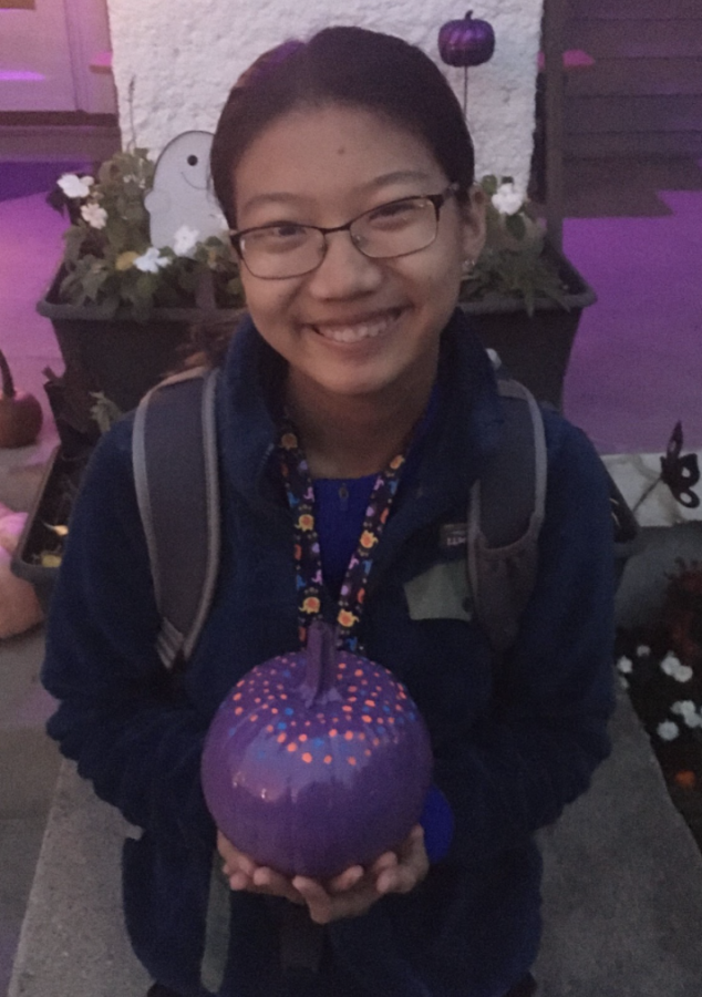 Freshman Lianne Guttadauro is smiling with her polka-dotted purple pumpkin that she painted to earn the purple pumpkin project pin.