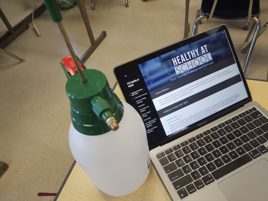 Image shows a disinfectant spray bottle and the Fort Thomas Independent School Healthy at School website.