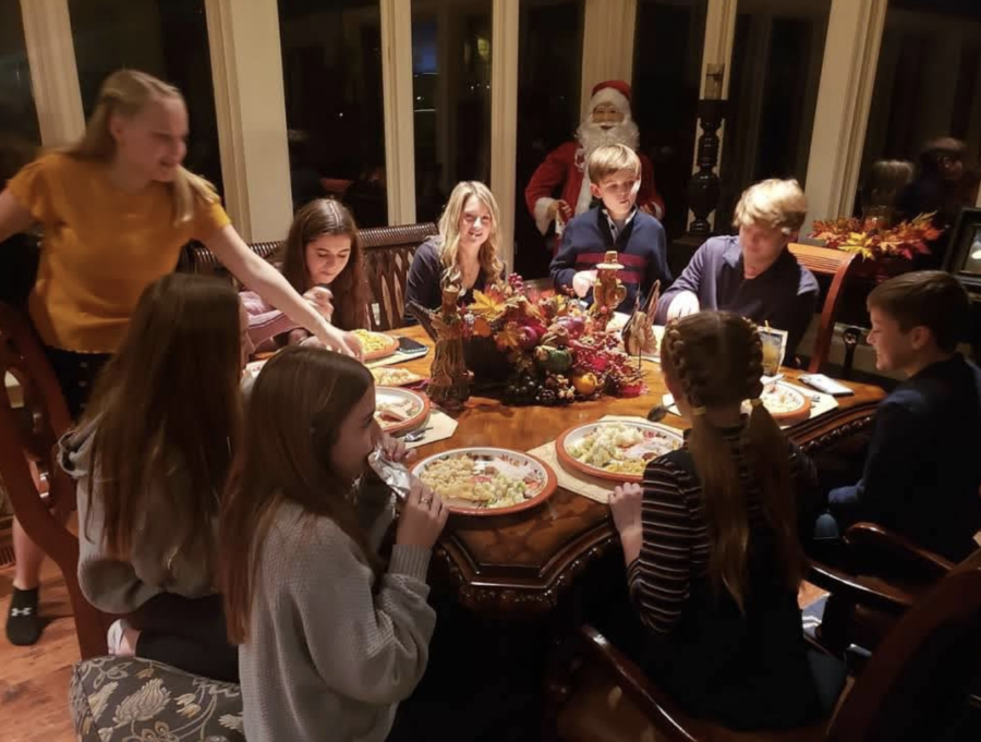 The Hosea family surrounds themselves with food and family as they get ready to start eating their meals. 