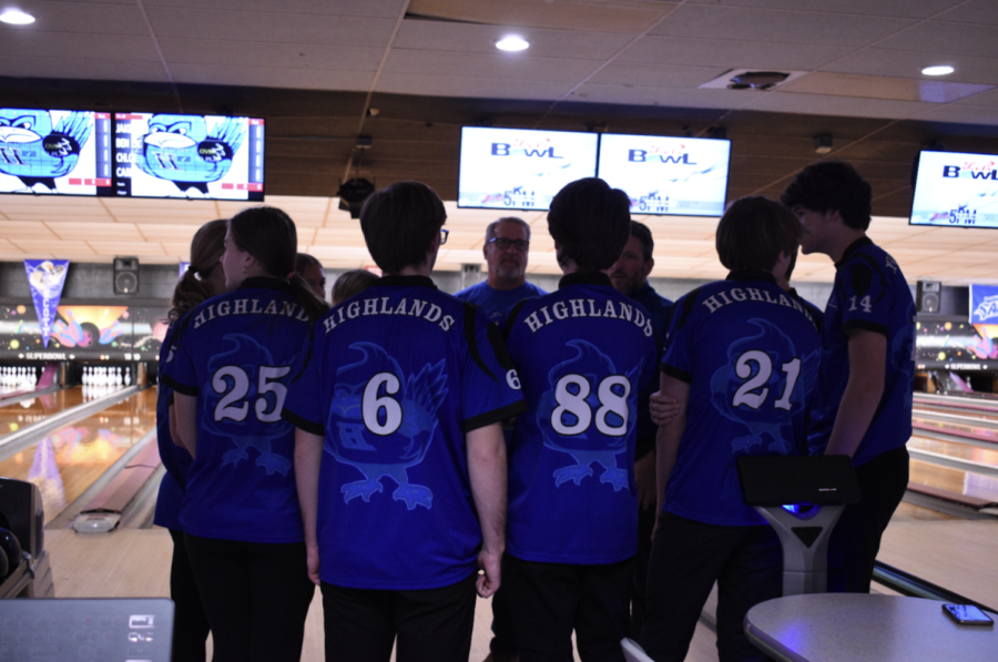 The bowling team groups together for a pep talk with their coach Andrew Eckerle. 