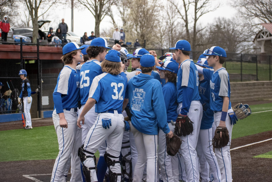The Freshman Baseball Birds huddle at home plate before the game.