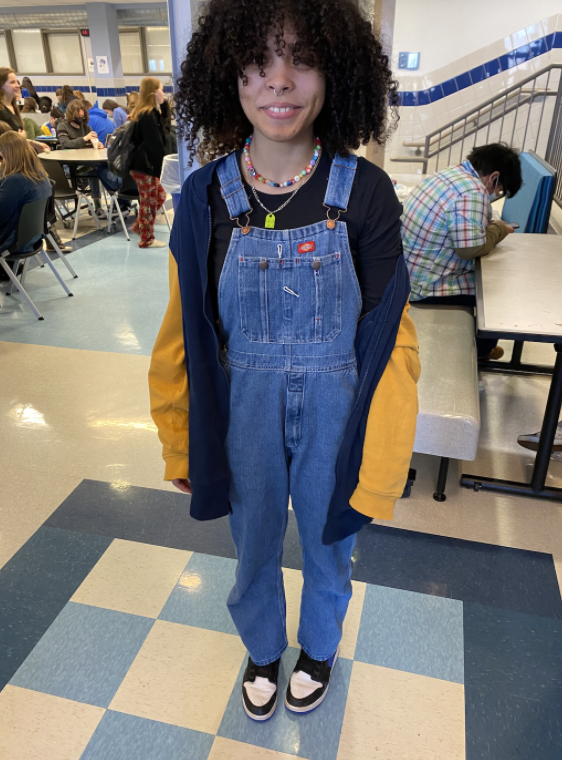 Junior Alyssa Williams poses in her overalls with a nice jacket over top.