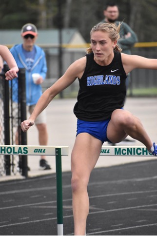 Senior Jade Rehberger clears the first hurdle in an attempt to get a good time in the race.