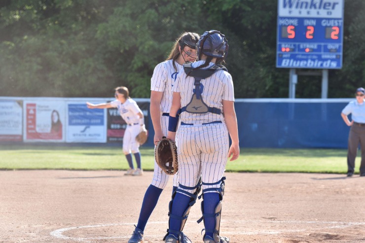 Sophomore Michelle Barth and Junior Kennedy Baioni talk at the mound.