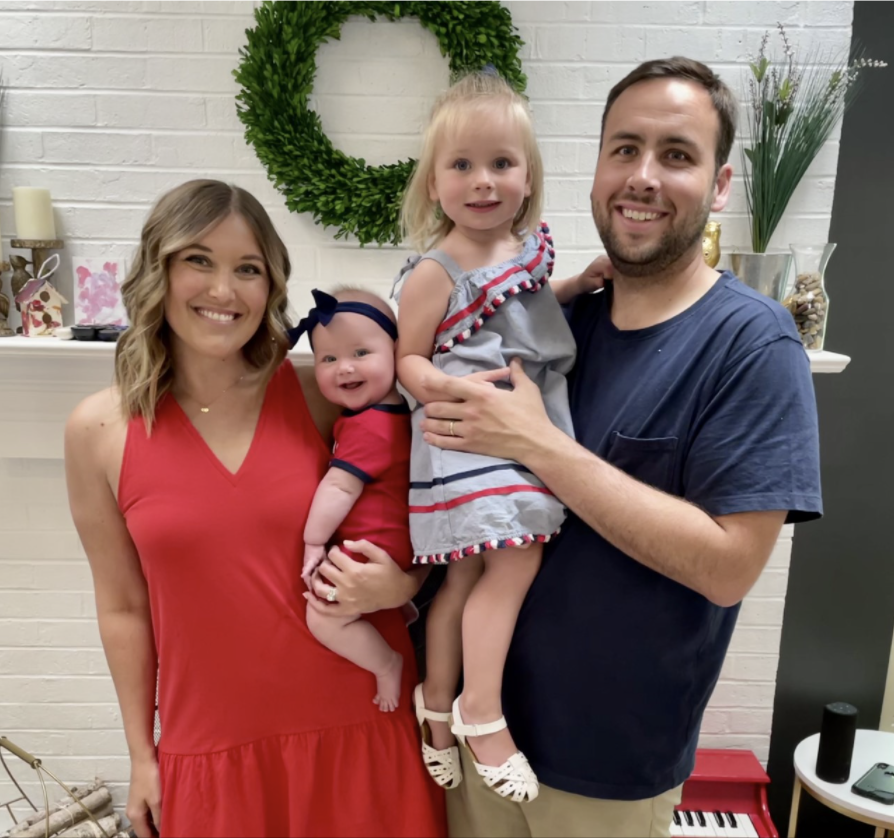 Samuel Volpenhein and Ericka Volpenhein smiling with their kids for a family photo.