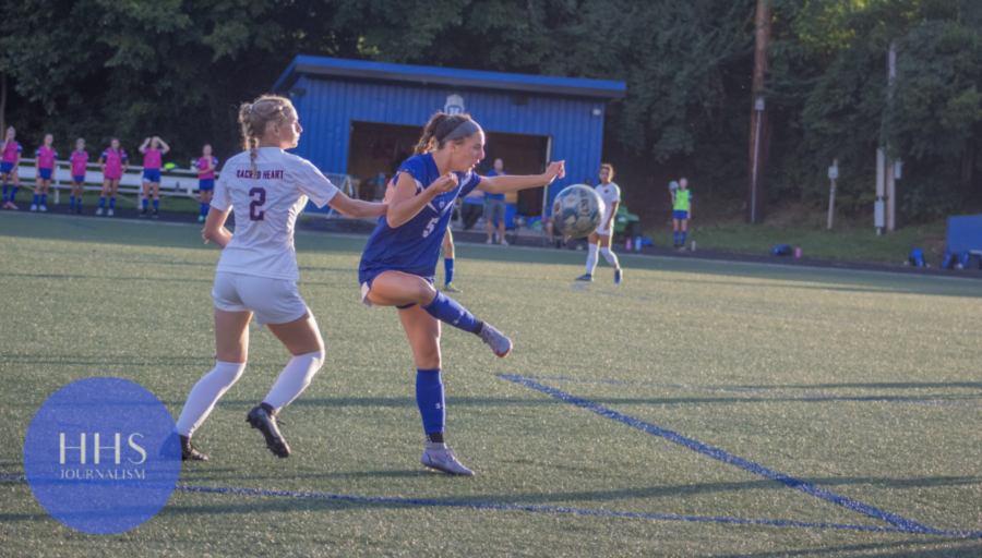 Junior Claire Cavacinni gets the ball and prepares to make a move on the defender. 
