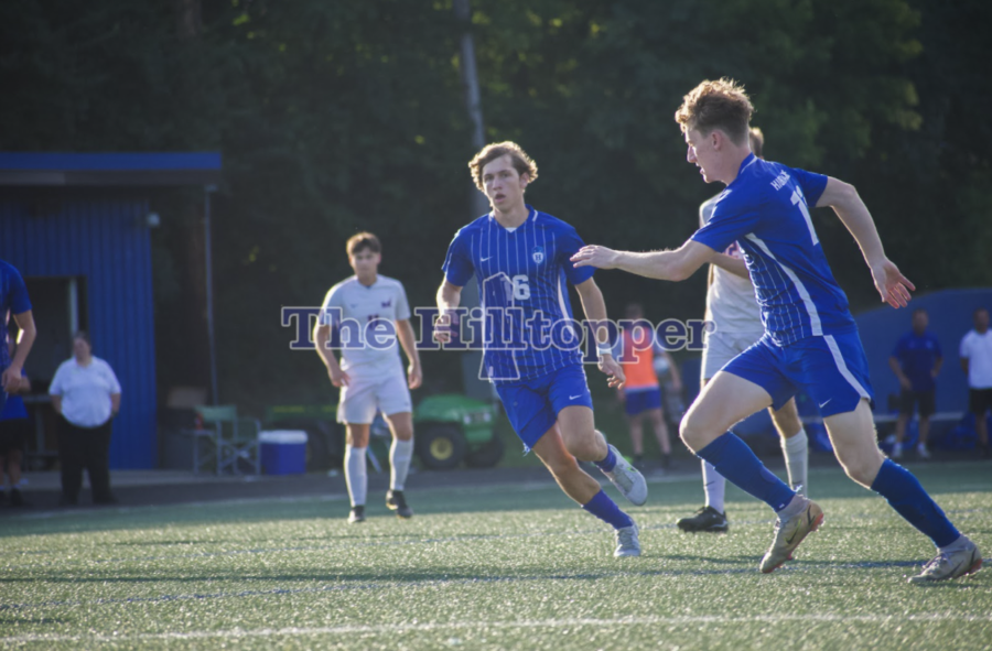 Seniors Peyton Helminiak and Casey Stiles running to get the ball from their opponent.