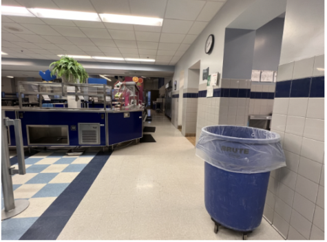 The cafeteria has large trash cans scattered throughout for students to use.