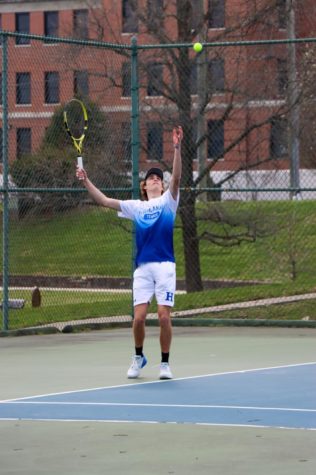Junior Eli Back serves the ball to his opponent.