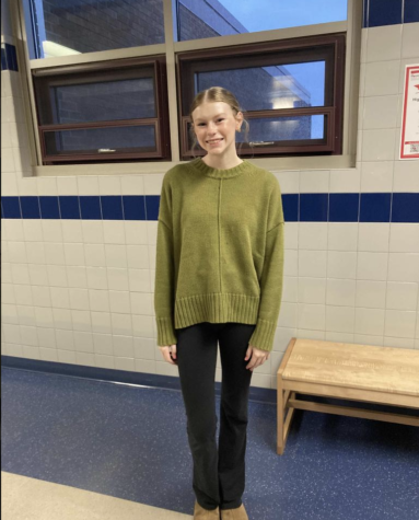 Sophomore Eva Sarakatsannis poses in her green top.