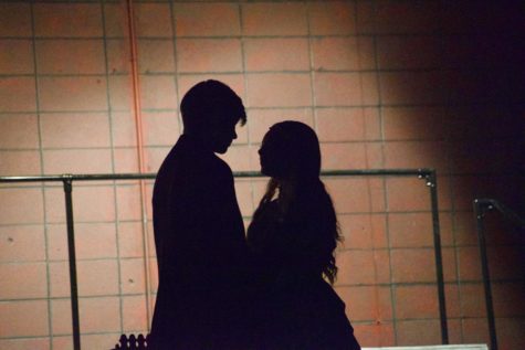 The silhouettes of Junior Jameson Zoller (Antony) and Senior Jonah Listerman (Johanna) share an intimate moment on stage.