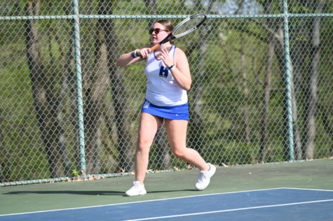 Junior Stella Halbauer hits the ball back during doubles warmups.(Liam)