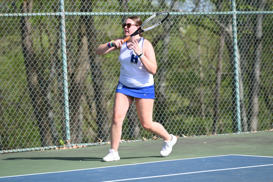 Junior Stella Halbauer hits the ball back during doubles warmups.(Liam)