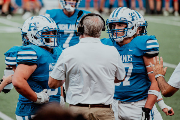 Highlands defensive line coach, Mark Dill, talks to Senior Hollan Schweitzer and Aiden Howard in between the first and second quarter. 