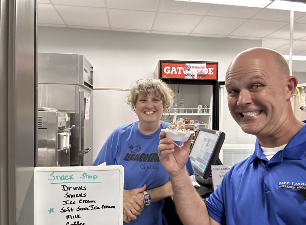 Robinson+and+Cafeteria+and+Food+Assistant%2C+Lisa+Kroger%2C+posing+with+their+first+servings+of+soft-serve.++%0A