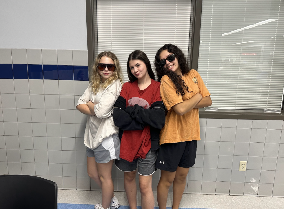 Sophomores Sophia French, Alivia Adkins, and Sophia Cabellero show off the outfits and shades. Adkins said, Live, laugh, love Adam Sandler.