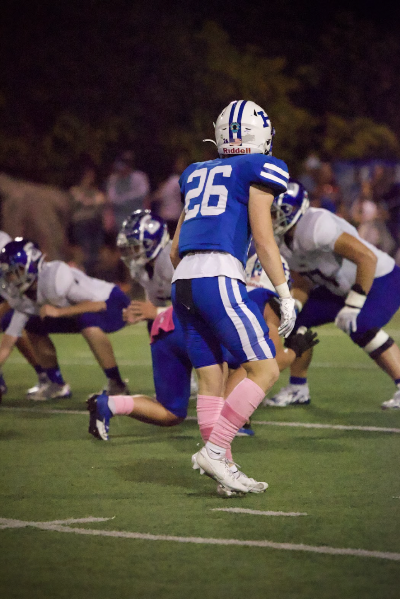Junior Ethan Grimm (26) takes his position on the line of scrimmage waiting for the upcoming play to begin