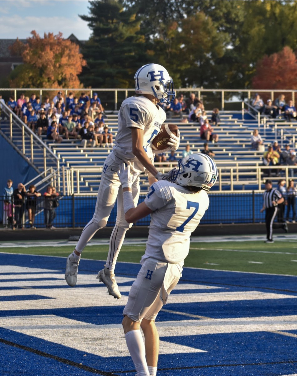 Freshman John Feldbruegge (5) accompanied by Freshman Chase Jacob (7) celebrate Feldbruegge's touchdown. Feldbruegge says, “I saw the crowd up and cheering, I felt like Simba from the Lion King."