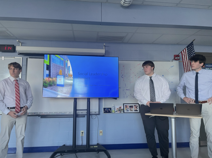 In+the+photo%2C+juniors+Josh+Hartung%2C+Diego+Race%2C+and+Hank+Shick+are+giving+their+business+presentation+about+their+experience+in+a+work+environment.+