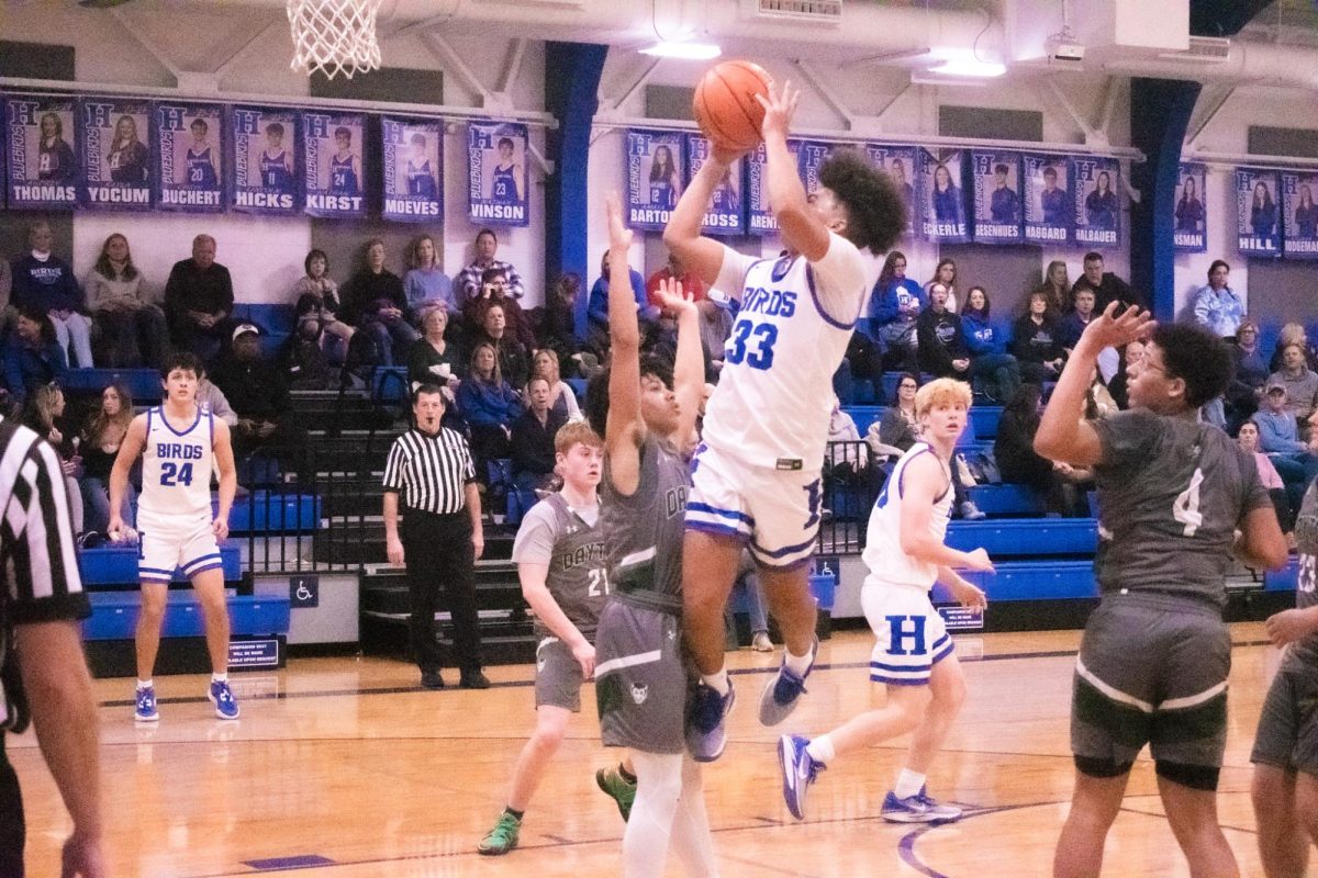 Junior Dominic Gregory (33) shoots the ball for a basket against Dayton. When asked about strategies used for this game he said We played man on man defense.