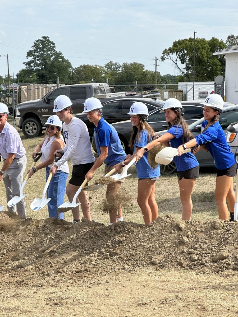  Colin Utz (12), Harrison Gamble (12), Sarah Jones (12), Kate Fausz (12), and Aaliyah Haretuku (9), and Amy Shaffer, Executive Director of the Fort Thomas Education Foundation, throws dirt in the air to celebrate.