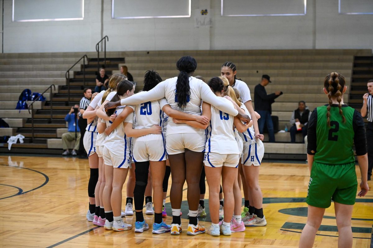 Before the game began the girls huddle to wish good luck to their teammates.