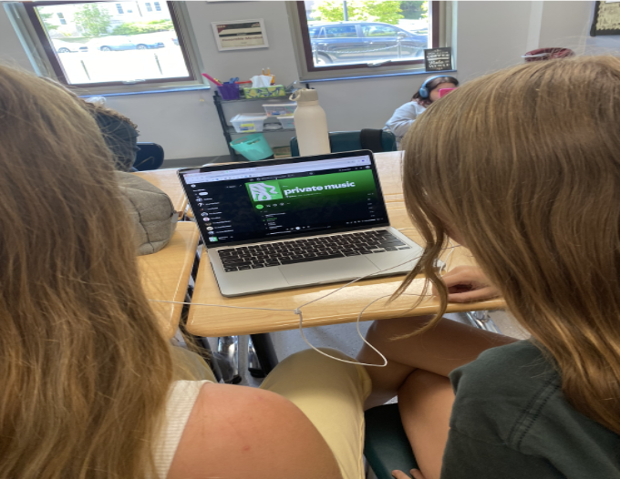 Stella Taylor (10) and Natalie Abdon (10) listen to the new Deftones album.