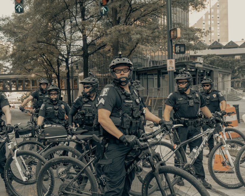 Federal officers patrol city streets on bikes, Clay Banks, Unsplash.
