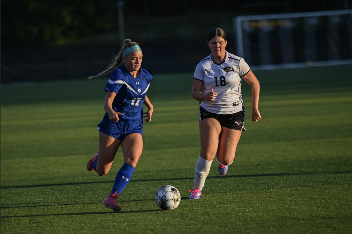 Gabriella Simon (11) competes with a Bellevue player for the ball. "Overall there were some things we could've done better, but coming out with our first win was great," Simon said.