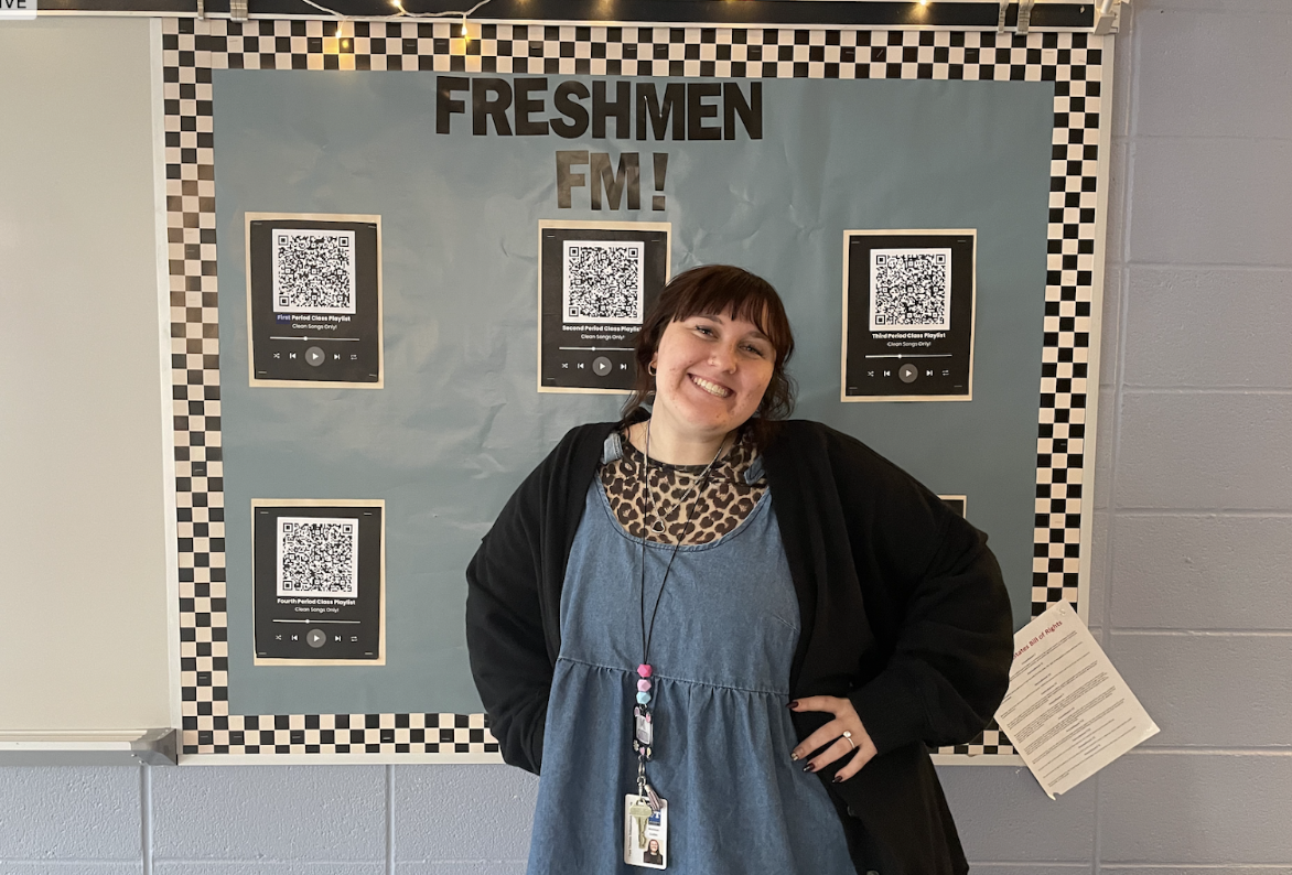Maddie Griffith poses in front of the bulletin board in her new classroom.