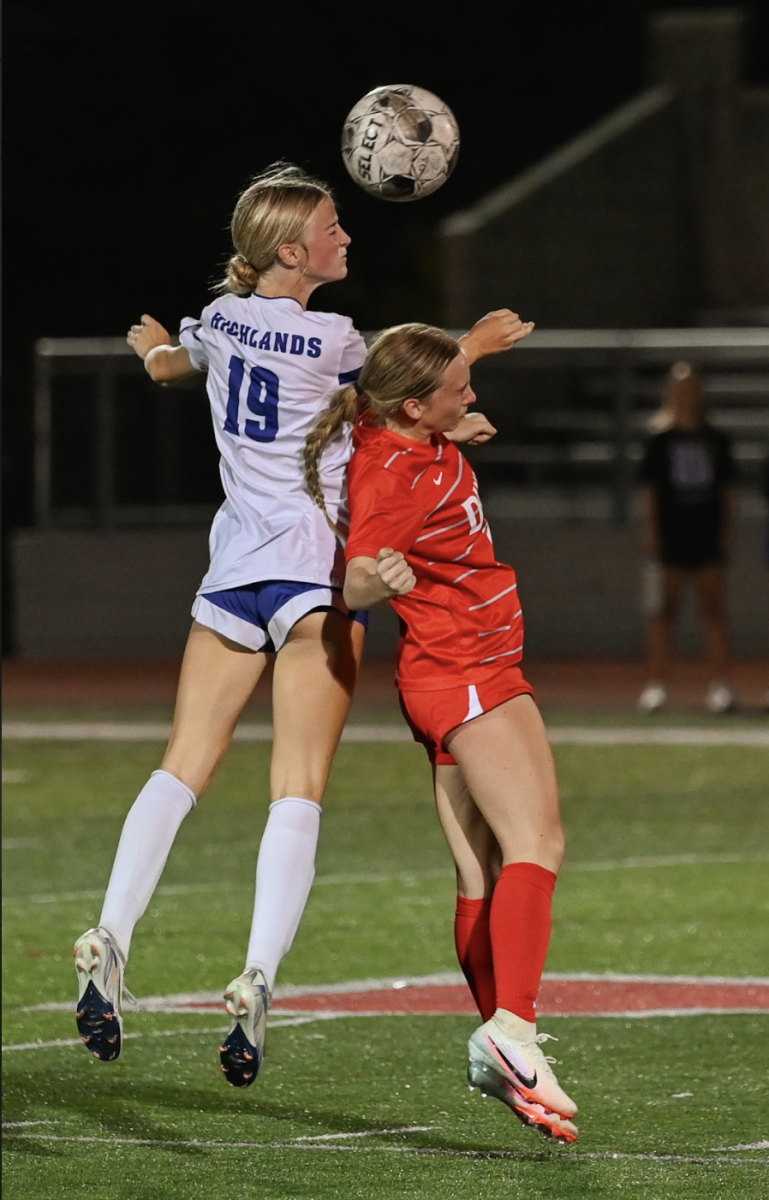 Macy Hargis (12) heads the ball. "I think that it was probably our best game so far in terms of wanting it, and I think that last night we really came together as a team," Hargis said.