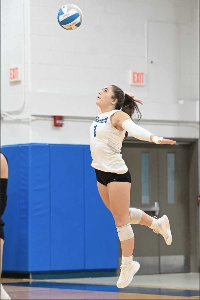 Hayden Gessner (12) serves the ball. “Sweeping any team is always amazing because it truly shows the hard work we put in to really execute during our games,” Gessner said.