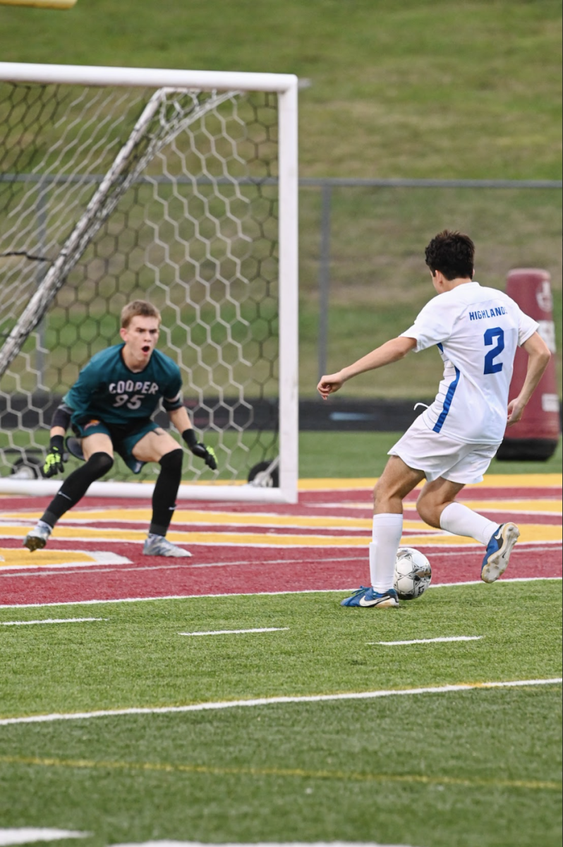 Wyatt Zepf (12) kicks the ball into the goal.