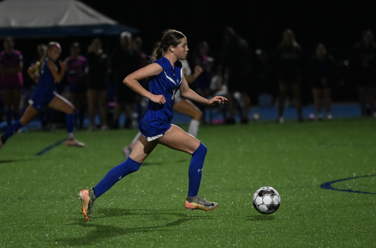Tenley Graves (12) dribbles the ball.