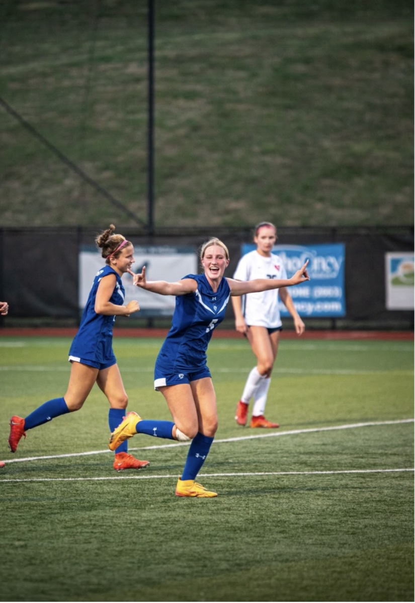 Natalie Heingardener celebrates after Tenley Graves scores a goal against Sacred Heart High School.