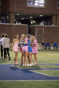 Ella Cunningham (‘25) is congratulated by her friends after winning homecoming queen at the football game (Provided by Ella Cunningham).