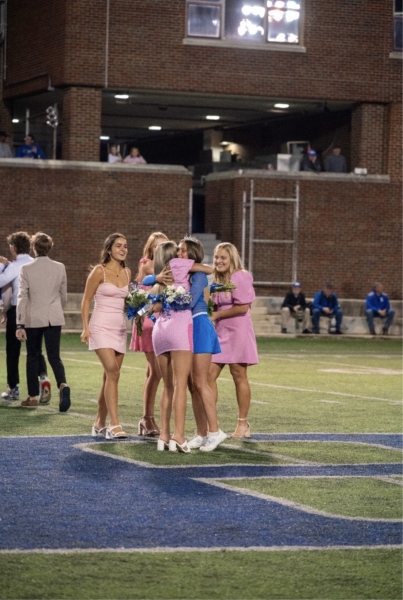 Ella Cunningham (‘25) is congratulated by her friends after winning homecoming queen at the football game (Provided by Ella Cunningham).