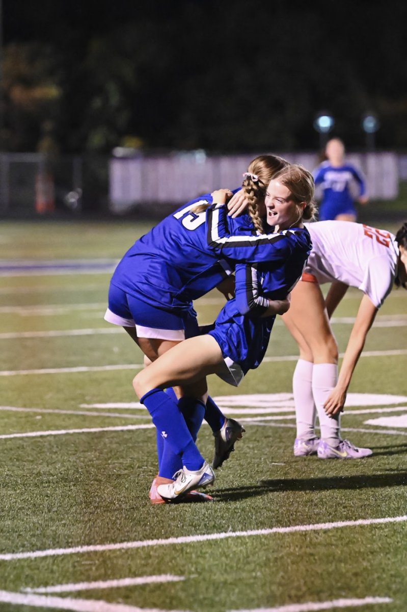 Katie Bucher (12) and Macy Hargis (12) hug after a goal is scored. “Beating any team in region is always great, but doing it by 4 goals boosted our confidence. It is exactly what we needed going into the game against Notre Dame”, Bucher said.
