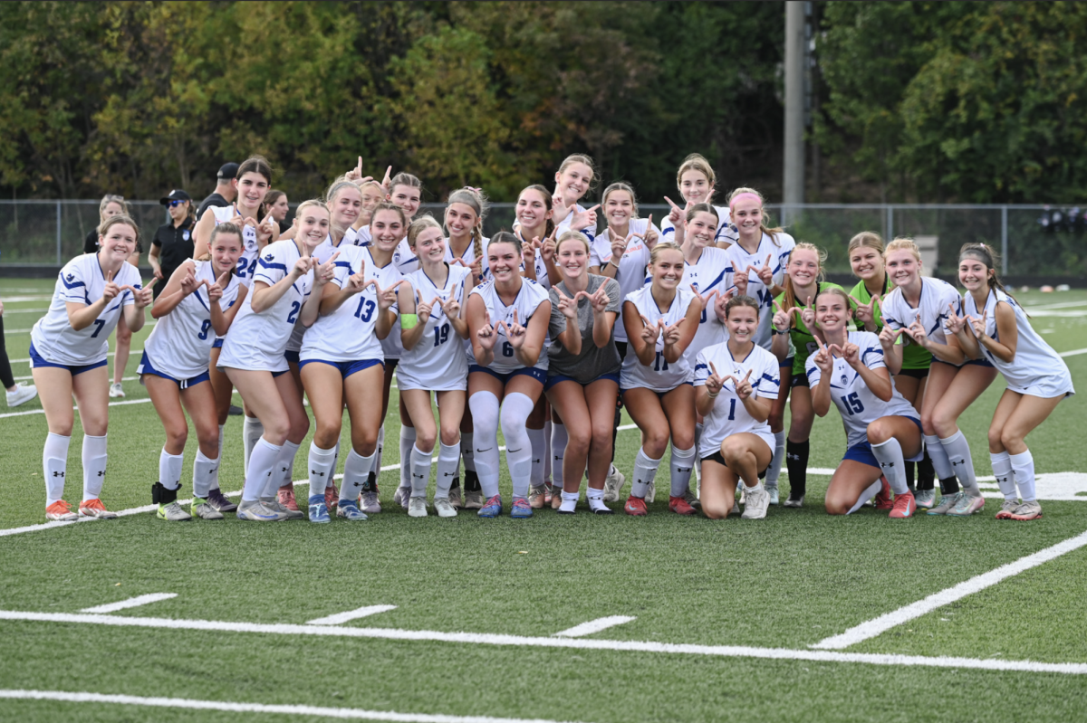 The Highlands girls soccer team holds up "W" after taking down Notre Dame Academy.