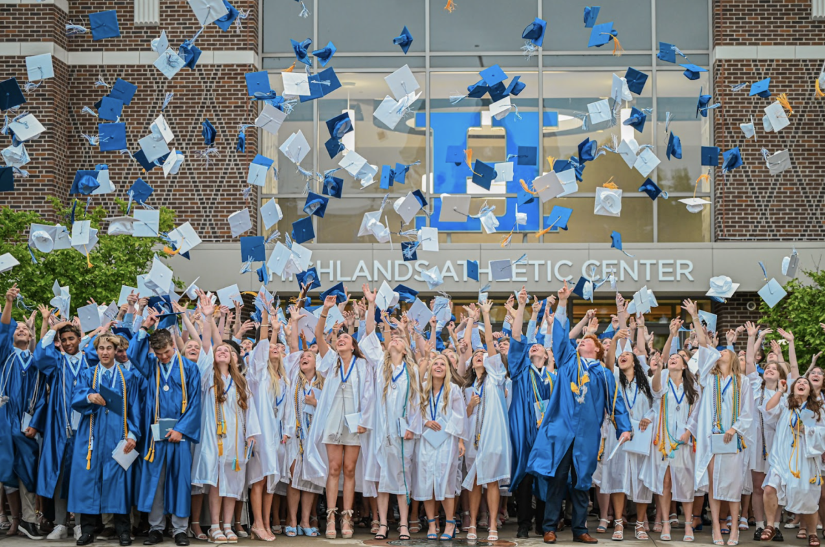 Class of 2025 celebrates graduation by throwing their caps.