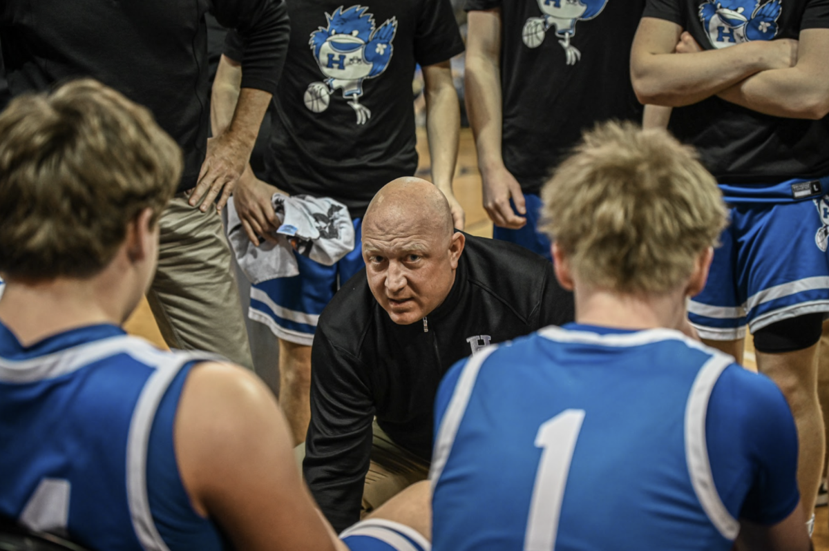 Coach Kevin Listerman gets the team together to discuss their next play.