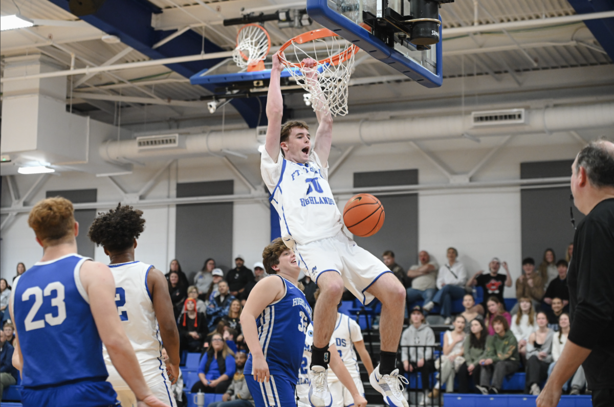 Gabe Gracey (10) dunks into the hoop.
