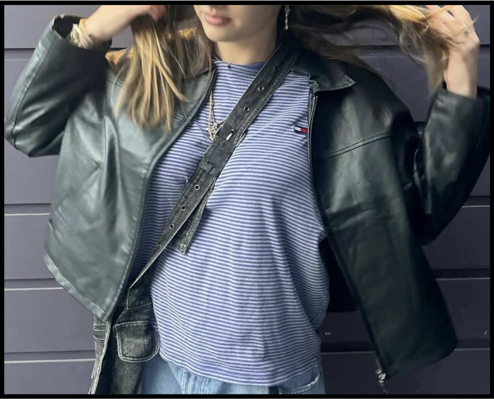 Riley Steinhauser (12) models a casual yet stylish outfit this winter composed of baggy blue jeans, a leather jacket, and a striped shirt paired with the cutest accessories (Courtesy of Bella Burwick). 